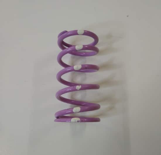 A purple Ski-Doo TRA Clutch Spring Violet/White on a white surface.